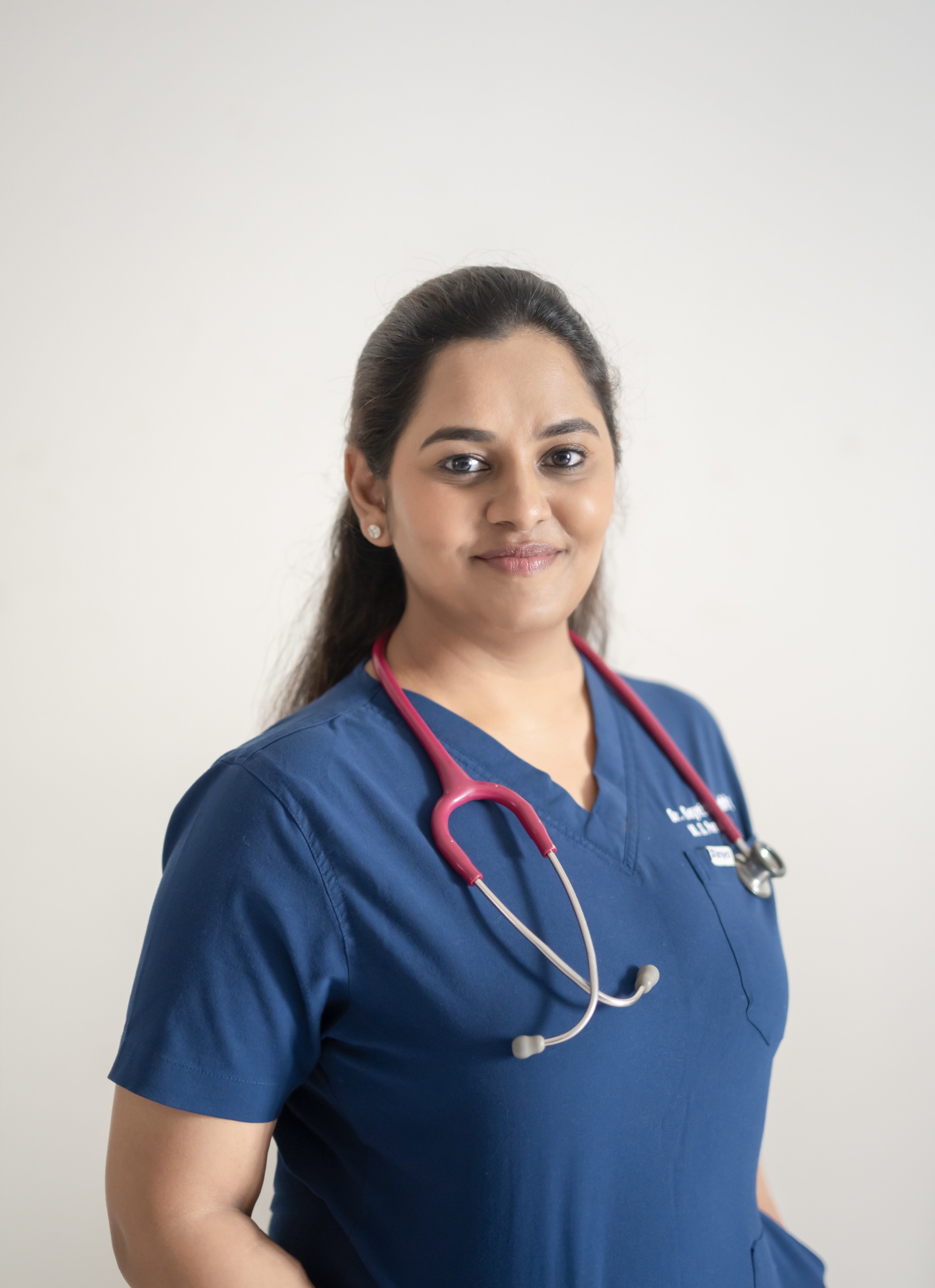 Dr. Gayathri Reddy in blue scrubs